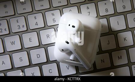 Apple AirPods and keyboard Stock Photo