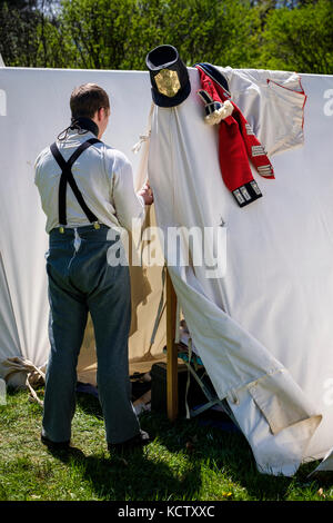 Battle of Longwoods reenactment, Anglo-American War of 1812, March 1814, British soldier dressing for battle at camp, Delaware, Ontario, Canada. Stock Photo