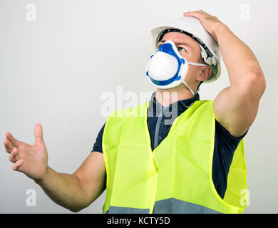 worker in white helmet and respirator Stock Photo