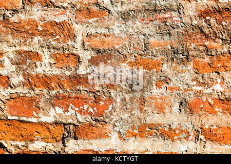 Old weathered grunge red brick wall as background Stock Photo