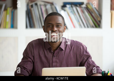 Head shot portrait of smiling handsome african american businessman. Young casually dressed freelance business owner, office worker looks at camera, p Stock Photo