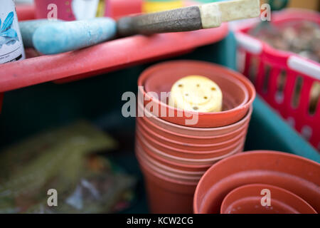 Close up of flower pots and tools in a green house or potting shed Stock Photo