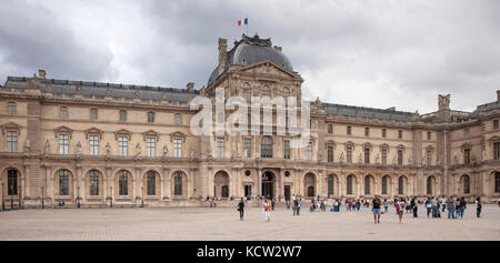 PARIS, FRANCE - AUGUST 17: Tourists in the Square Court of Louvre Palace in front of Pavillon Sully, August 17, 2017 in Paris, France Stock Photo