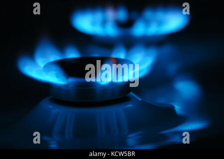 Two gas cooker burners lit in the dark Stock Photo