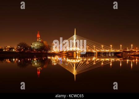 Reflection of Esplanade Riel Bridge and Canadian Museum for Human Rights in the Red River at night, Winnipeg, Manitoba, Canada Stock Photo