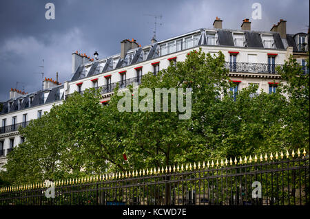 Luxembourg gardens fence and apartment buildings surrounding the park. Stock Photo