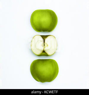 Green apples Fresh granny smith Three different halves of green apples are lying vertically in a row on a white background Stock Photo