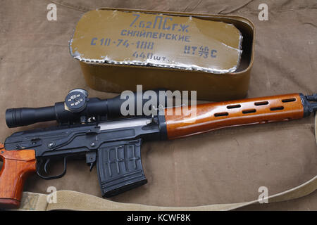 SVD sniper rifle with box of ammunition on canvas background. The inscription translates as 'Snipers Ammunitions' Stock Photo