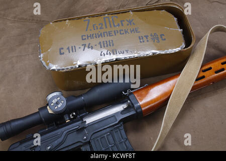 SVD sniper rifle with box of ammunition on canvas background. The inscription translates as 'Snipers Ammunitions' Stock Photo