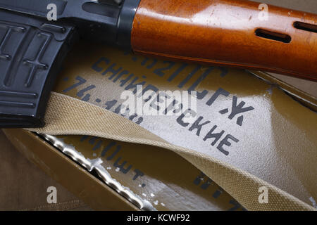 SVD sniper rifle with box of ammunition on canvas background. The inscription translates as 'Snipers Ammunitions' Stock Photo