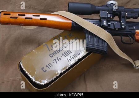 SVD sniper rifle with box of ammunition on canvas background. The inscription translates as 'Snipers Ammunitions' Stock Photo