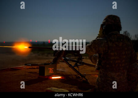 U.S. Soldiers assigned to the 1050th Transportation Battalion and 151st Expeditionary Signal Battalion, S.C. Army National Guard conduct M2 machine gun night firing during crew-served weapons familiarization training at Fort Jackson, S.C., Sept. 15, 2016.  30 Soldiers from multiple transportation and signal companies train on dismounted security drills and crew-served weapons in preparation for their qualification next summer and to stay current with convoy security. (U.S. Air National Guard photo by Tech. Sgt. Jorge Intriago) Stock Photo