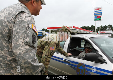 Col. Jeffrey Jones, Commander 218th Maneuver Enhancement Brigade (left) and Col. Richard Wholey, Commander 678th Air Defense Artillery (center), talk with Spc. Dominique Dotson, Headquarters and Headquarters Battalion, 263rd Air Defense Artillery and Troopers assisting with evacuations in preparing for Hurricane Matthew Oct. 6, in Conway, S.C. Approximately 1,400 South Carolina National Guard Soldiers and Airmen were activated Oct. 4, 2016 to support state and county emergency management agencies and local first responders after Governor Nikki Haley declared a State of Emergency. (Photo by Sgt Stock Photo
