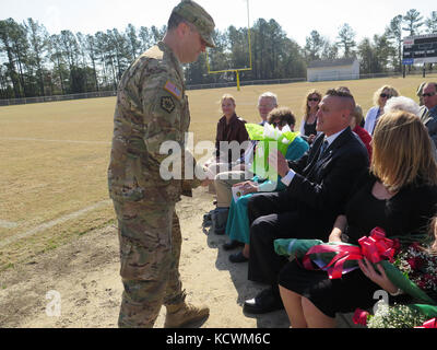 The South Carolina Army National Guard’s 51st Military Police Battalion conducted a change of command ceremony at Florence Memorial Stadium in Florence, South Carolina, Feb. 12, 2017. The outgoing commander Lt. Col. Jason Turner relinquished command to Maj. Erika Perry. (Courtesy Photo) Stock Photo