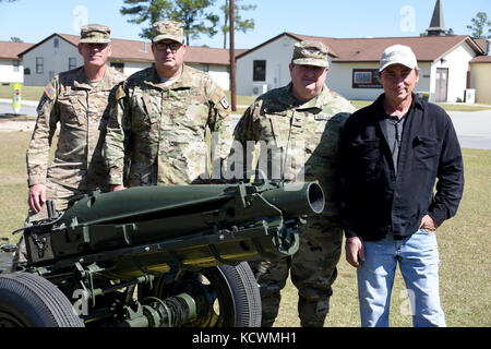From left to right, U.S. Army Maj. Dale Goff, Maj. Christopher Rauch and Col. Larry Peeples stand with Gordon Ponsford, a restoration expert, behind Ponsford's latest project - a 1943 75mm Pack Howitzer, which is stationed on the parade field at the South Carolina National Guard's McCrady Training Center in Eastover, South Carolina, March 9, 2017.  Ponsford has restored many former South Carolina National Guard weapons systems and vehicles around the state to original looking condition, with this particular howitzer having lineage back to Burma in World War II, as well as the Korean War.  The 