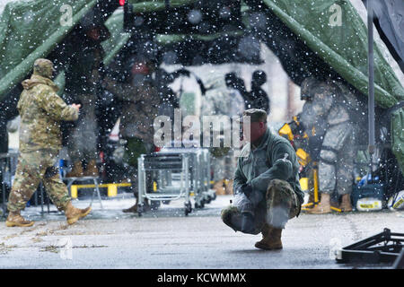 U.S. Army Sgt. Brian Calhoun, public affairs specialist for the South Carolina Army National Guard, takes a knee while on assignment during a joint exercise at Rosewood Center, Owings Mills, Maryland, March 10, 2017.  The 251st along with the 231st Chemical Company, Maryland Army National Guard, are participating in an U.S. Army North validation exercise where they will be setting up a full medical area and conducting triage at a casualty collection point. (U.S. Air National Guard photo by Tech. Sgt. Jorge Intriago)  Stock Photo