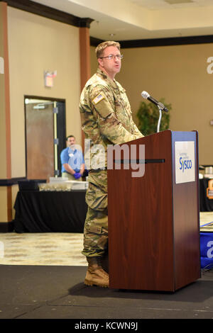 U.S Army Capt. John Denny, a chaplain assigned to the South Carolina National Guard gives the Invocation during the 3rd annual Operation Palmetto Employment Summit in Columbia, South Carolina, April 13, 2017. The OPE is designed to bring new companies together and educate them on the benefits of hiring a service member or veteran.(U.S. Army National Guard photo by Spc. Chelsea Baker) Stock Photo