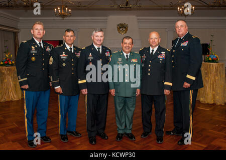 L-R) U.S. Army Maj. Paul Smith, Command Sgt. Maj. Carlos Olvera, Command Sergeant Major, United States Army South, U.S. Army Maj. Gen. Robert Dyess, Deputy Director for the U.S. Army Capabilities Integration Center, Colombian Army Maj Gen. Fernando Pineda, U.S. Army Maj. Gen. Robert E. Livingston, Jr., the adjutant general for South Carolina, and U.S. Army Brig. Gen. R. Van McCarty, deputy adjutant general for South Carolina attend a reception following the induction ceremony of the Colombian Army Doctrine Plan (DAMASCO) at the Escuela Militar de Cadetes in Bogota, Colombia, Aug. 5, 2016. (Pho Stock Photo