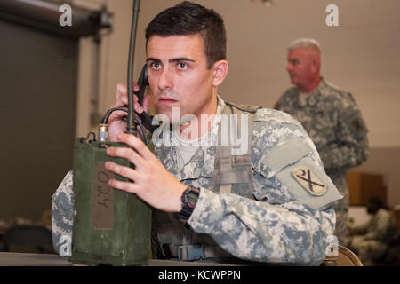 U.S. Army Sgt. Brandon McCarty, Alpha Co., 1st Battalion, 118th Infantry Regiment, 218th Maneuver Enhancement Brigade, South Carolina National Guard, programs a radio check after assembly and programming in North Charleston, South Carolina, Oct. 23, 2016, as part of the battalion-level Best Warrior Competition. The selection board for the competition consisted of four voting members evaluating candidates' skills and knowledge in areas such as the Army Physical Fitness Test, land navigation, self-aid and buddy care, Army programs and current events. One Soldier and one non-commissioned officer, Stock Photo