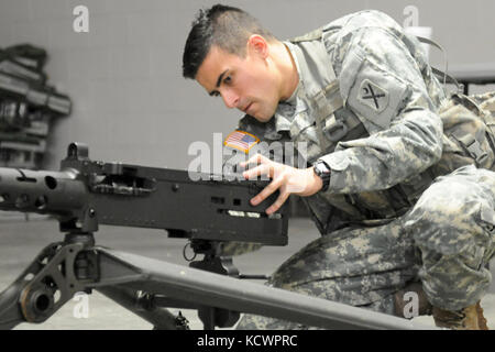 U.S. Army Sgt. Brandon McCarty, 1st Battalion 118th Infantry Regiment, 218th Maneuver Enhancement Brigade, South Carolina National Guard, assembles a M2A1 .50-caliber machine gun during the battalion-level Best Warrior Competition in North Charleston, South Carolina, Oct. 23, 2016.The selection board for the competition consisted of four voting members evaluating candidates' skills and knowledge in areas such as the Army Physical Fitness Test, land navigation, self-aid and buddy care, Army programs and current events. One Soldier and one non-commissioned officer, along with an alternate for ea Stock Photo