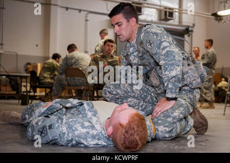 U.S. Army Sgt. Brandon McCarty, Alpha Co., 1st Battalion, 118th Infantry Regiment, 218th Maneuver Enhancement Brigade, South Carolina National Guard, evaluates a casualty in North Charleston, South Carolina, Oct. 23, 2016, as part of the battalion-level Best Warrior Competition. The selection board for the competition consisted of four voting members evaluating candidates' skills and knowledge in areas such as the Army Physical Fitness Test, land navigation, self-aid and buddy care, Army programs and current events. One Soldier and one non-commissioned officer, along with an alternate for each Stock Photo