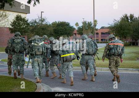 Soldiers from 1st Battalion, 118th Infantry Regiment, 218th Maneuver Enhancement Brigade, South Carolina National Guard, participate in a six-mile ruck march in North Charleston, South Carolina, Oct. 23, 2016, as part of the battalion-level Best Warrior Competition. The selection board for the competition consisted of four voting members evaluating candidates' skills and knowledge in areas such as the Army Physical Fitness Test, land navigation, self-aid and buddy care, Army programs and current events. One Soldier and one non-commissioned officer, along with an alternate for each, will compet Stock Photo