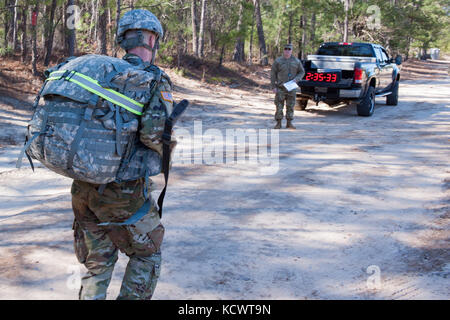 U.S. Army Spc. James Ouzts, 263rd Army Air and Missile Defense Command, South Carolina Army National Guard, approaches the finish line of the 12-mile foot march portion of the Best Warrior 2017 Competition at McCrady Training Center in Eastover, South Carolina, Jan. 29, 2017. The five-day event consisted of a road march, physical fitness test, and weapons qualification events, among others. Participants competed as individuals with an enlisted and non-commissioned officer winner being announced Feb. 1, 2017. (U.S. Army National Guard photo by Sgt. Brian Calhoun, 108th Public Affairs Det.) Stock Photo
