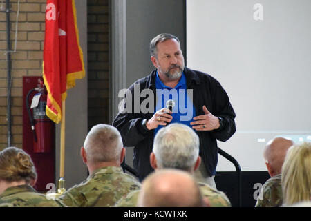 Mr. Kenneth Braddock, state operations chief of staff, speaks to the crowd of more than 150 Soldiers, Airmen, and civilians gathered at the Bluff Road armory in Columbia, South Carolina for a Town Hall meeting Mar. 1, 2017, to address concerns and discuss the way ahead for the South Carolina Military Department. (U.S. Army National Guard photo by Capt. Jessica Donnelly) Stock Photo