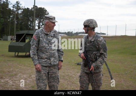 U.S. Army Command Sgt. Maj. Robert Brickley, State Command Sergeant Major, South Carolina National Guard, visits with South Carolina Army National Guard Soldier Spc. Robert McCoy, 4-118th Infantry, as he competes in the Region III 2016 Best Warrior Competition held at Fort Stewart, Georgia, April 17-22, 2016. McCoy and Sgt. Robert Caldwell, 1-118th Infantry, represented South Carolina in the 2016 competition. (U.S. Army National Guard Photo by Capt. Brian Hare/Released) Stock Photo