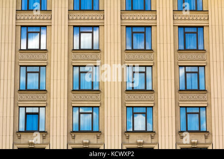 Details of windows of new constructed colorful multi-story building. Modern residential construction. Residential fund. Building of the city. New yell Stock Photo