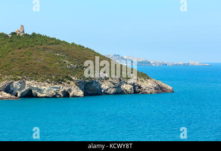 Summer sea coast near Architello (Arch) of San Felice and Vieste town in far (Gargano peninsula in Puglia, Italy) Stock Photo