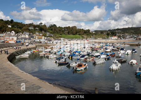 View over boats moored in The Cobb and the old town behind, Lyme Regis, Dorset, England, United Kingdom, Europe Stock Photo