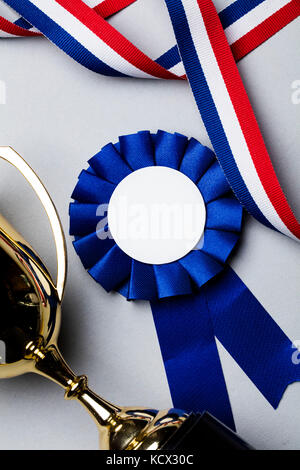 First place trophy and award rosette.  Success achievement concept Stock Photo