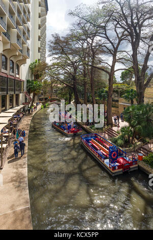 San Antonio Riverwalk river cruises with tourists on boats, Texas, USA Stock Photo