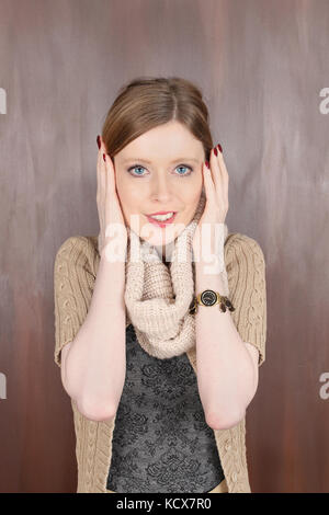 Girl with wool scarf covering her ears keeping herself warm Stock Photo