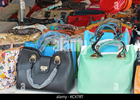 Fake high-end fashion brand name famous designer purses and backpacks on  display for sale at a local outdoor flea market in Ventimiglia, Italy Stock  Photo - Alamy