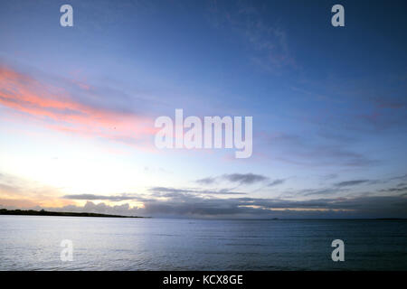Vanilla clouds, sunset over the ocean in Iceland. Stock Photo