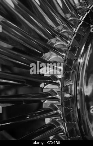 Turbine fan blades viewed from a cutaway of a small jet engine exposing the curved fan blades that duct air for power. Stock Photo