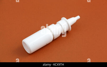 picture of a medicine spray bottle nasal , brown background Stock Photo