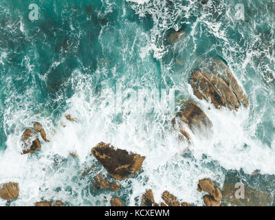 Atlantic Ocean waves crashing into the boulders of South Africa's Maidens Cove in Cape Town. Stock Photo