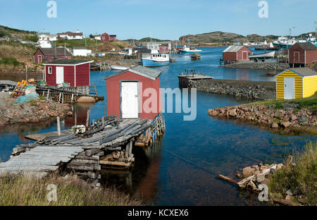 Newfoundland Fishing Village:  Fishing shanties sit on rustic wooden piers and rock jetties that extend into a small north coast harbor. Stock Photo