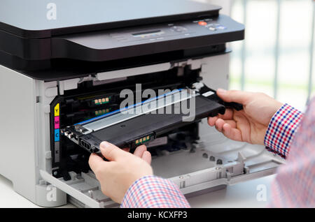 Man replacing toner in laser printer. toner printer cartridge print laser office supplies refill concept Stock Photo