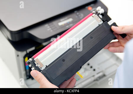 Man replacing toner in laser printer. toner printer cartridge print laser office supplies refill concept Stock Photo