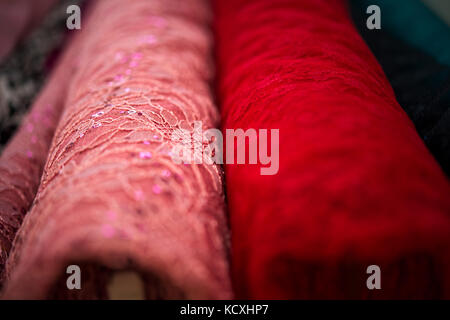 Stack of fabric two pink redl cloth rolls Stock Photo