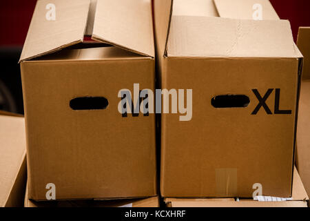 Two carton cardboard boxes with letters M and XL size Stock Photo