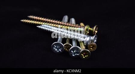 Abstract cross-head or Phillips-head or recessed-head screw on black Background, Stock Photo