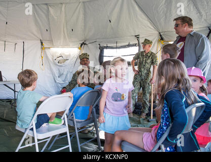 SAN FRANCISCO (Oct. 6, 2017) Engineman 2nd Class Jeson Williams and Seaman Dakota Koenke, attached to Amphibious Construction Battalion (ACB) 1, talk to guests about ACB 1’s humanitarian assistance and disaster response capabilities, during Fleet Week San Francisco 2017. Fleet week provides an opportunity for the American public to meet their Navy, Marine Corps, and Coast Guard team and to experience America’s sea service. Fleet Week San Francisco will highlight naval personnel, equipment, technology, and capabilities, with an emphasis on humanitarian assistance and disaster response.  (U.S. N Stock Photo