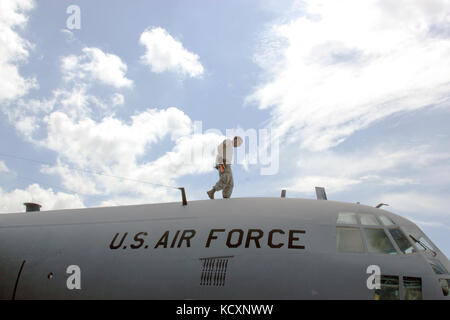 An Air National Guard maintenance technician performs routine maintenance on a C-130 Hercules at Muniz Air National Guard Base, Puerto Rico, ensuring aircraft readiness and operational capability for mission requirements. Stock Photo