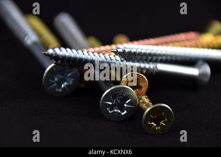 Abstract cross-head or Phillips-head or recessed-head screw on black Background, Stock Photo