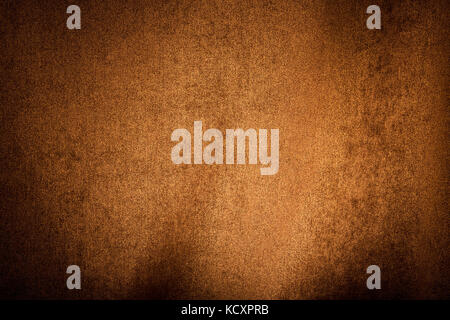 An orange and brown textured background with variations in light. Stock Photo
